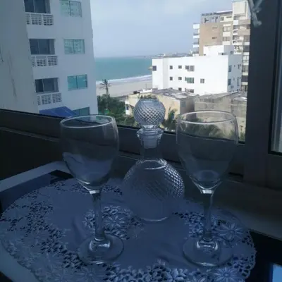 two wine glasses sitting on a table in front of a window at Estudio tipo Loft Amoblado en Bocagrande Cartagena 801A in Cartagena de Indias