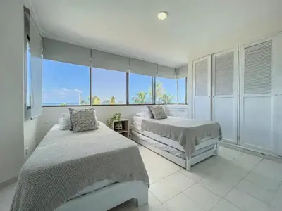 a bedroom with two beds and a view of the ocean at Cartagena beach front in Cartagena de Indias