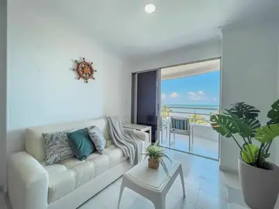 a white living room with a couch and a table at Cartagena beach front in Cartagena de Indias
