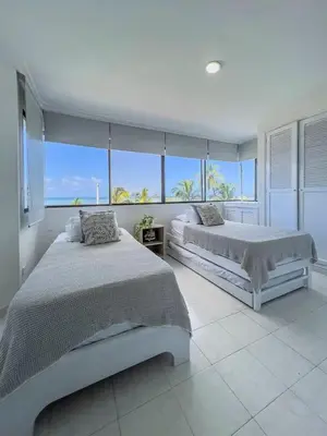 two beds in a bedroom with a view of the ocean at Cartagena beach front in Cartagena de Indias