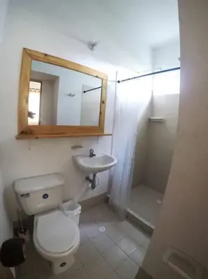 a bathroom with a toilet and a sink and a mirror at Apartamento frente al mar mejor playa en Coveñas in Coveñas