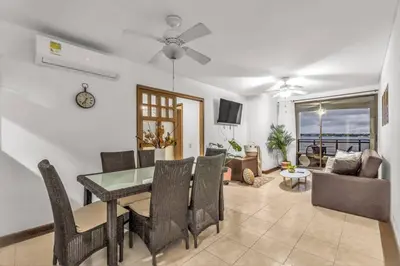 a dining room and living room with a table and chairs at Beachside Escape 2BR with Pool in Cartagena de Indias