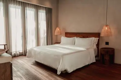 a bedroom with a large bed with white sheets and pillows at Makani Luxury Cartagena in Tierra Bomba