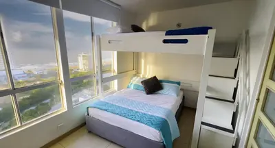 a bedroom with a bunk bed and a large window at Apartamento Cielo Cartagena in Cartagena de Indias