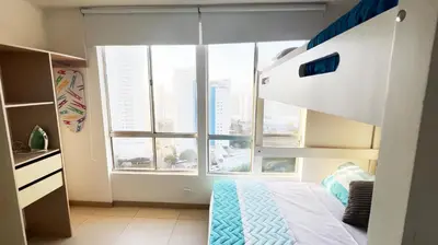 a bedroom with a bunk bed and a large window at Apartamento Cielo Cartagena in Cartagena de Indias