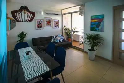 a living room with a table and a couch at Apartamento Cielo Cartagena in Cartagena de Indias