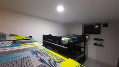 a bedroom with a bed and a flat screen tv at HOSTAL EL ALTISIMO in Cartagena de Indias