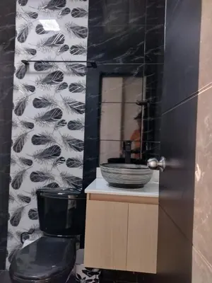 a bathroom with a sink and a toilet and a mirror at Apartahotel Los Ángeles in Cartagena de Indias