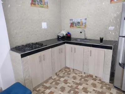 a kitchen with a sink and a stove in it at Apartahotel Los Ángeles in Cartagena de Indias