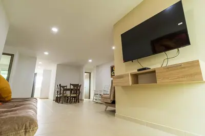 a living room with a flat screen tv on a wall at Makadamia Aptos in Sincelejo