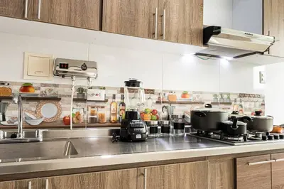 a kitchen with a stainless steel counter top with pots and pans at Makadamia Aptos in Sincelejo