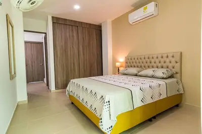 a bedroom with a large bed in a room at Makadamia Aptos in Sincelejo