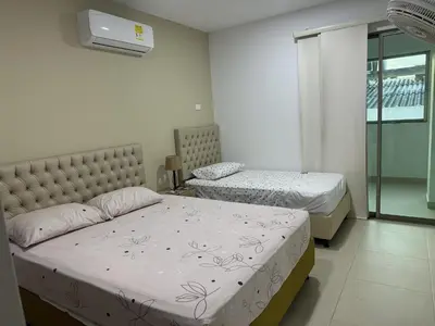 a bedroom with two beds and a window at Makadamia Aptos in Sincelejo