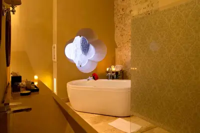 a bath tub in a bathroom with a light at Bastión Luxury Hotel in Cartagena de Indias