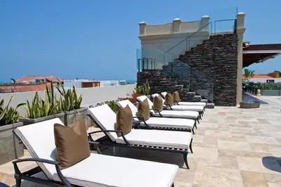 a row of chaise lounge chairs on a patio at Bastión Luxury Hotel in Cartagena de Indias