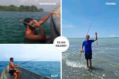 a man is in the water holding a fishing rod at Beach House with AC Surrounded by Nature in Moñitos