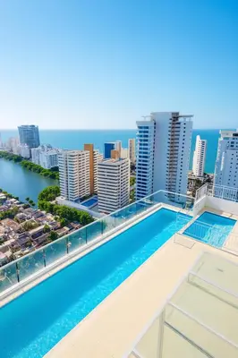 a swimming pool on the roof of a building with a city at Lindo apto vista al mar,central y piscina rooftop in Cartagena de Indias
