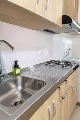 a kitchen with a sink and a stove at Lindo apto vista al mar,central y piscina rooftop in Cartagena de Indias