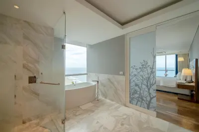 a bathroom with a tub and a glass shower at Hotel InterContinental Cartagena by IHG in Cartagena de Indias