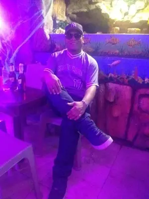 a man sitting on a bench in a bar at MoraRoom in Cartagena de Indias