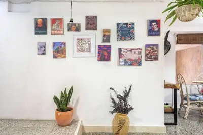 a white wall with pictures and a vase with a plant at Apartamento Central Frente al Mar Cartagena in Cartagena de Indias