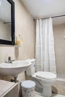 a bathroom with a toilet and a sink at Apartamento Central Frente al Mar Cartagena in Cartagena de Indias