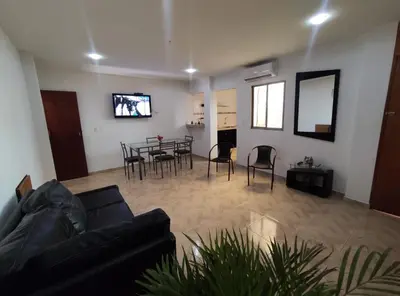 a living room with a couch and a table and chairs at Apartahotel Eden Coveñas in Coveñas