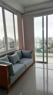 a couch in a room with large windows at Amazing views in Barranquilla in Barranquilla