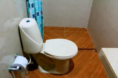 a bathroom with a toilet and a toilet paper dispenser at Apartment 1C11 Near The Sea With Pool in Cartagena de Indias