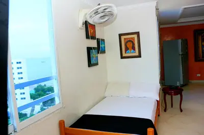 a small bed in a room with a window at Apartment 1C11 Near The Sea With Pool in Cartagena de Indias