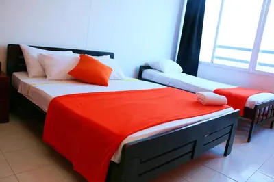a bedroom with two beds with orange and white pillows at Apartment 1C19 Close To The Sea With Pool in Cartagena de Indias