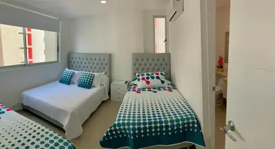 a bedroom with two beds with blue and white at Apartment al-2 facing the sea with Wifi in Cartagena de Indias