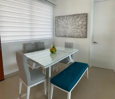 a dining room table with chairs and a vase on it at Apartment al-2 facing the sea with Wifi in Cartagena de Indias