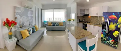 a living room with a couch and a kitchen at Apartment al-2 facing the sea with Wifi in Cartagena de Indias