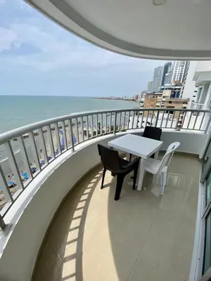 a balcony with a table and chairs and the ocean at Apartment al-1 facing the sea with pool and Wifi in Cartagena de Indias