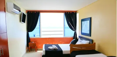 a bedroom with a bed and a large window at Studio Apartment E19C Close To The Sea And Pool in Cartagena de Indias
