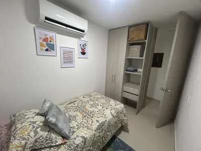 a small bedroom with a bed and a closet at Apartamento en Barranquilla Zona Norte Miramar in Barranquilla