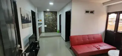 a red couch in a room with a hallway at 3 bedroom apartment 3CL3 in the old center in Cartagena de Indias