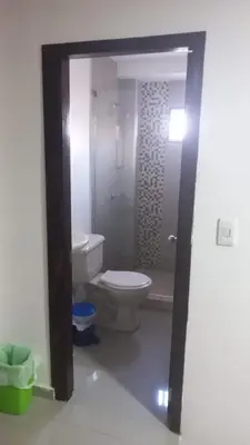 a bathroom with a white toilet and a shower at 3 bedroom apartment 3CL3 in the old center in Cartagena de Indias