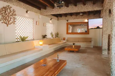 a living room with couches and a table at Hotel Rosario de Mar by Tequendama in Isla Grande