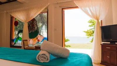 a bedroom with a bed with a view of the ocean at Hotel Rosario de Mar by Tequendama in Isla Grande