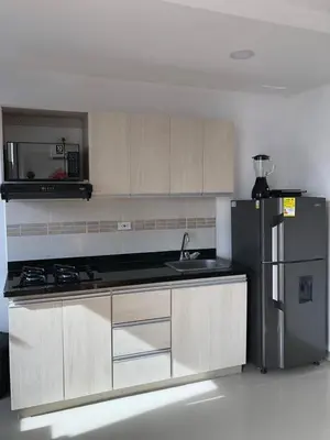 a kitchen with a stove and a refrigerator at Hermoso Apartamento en Caribe Campestre in Coveñas