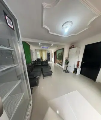 a living room with a couch and a tv at Hostal Viva Mar in Cartagena de Indias