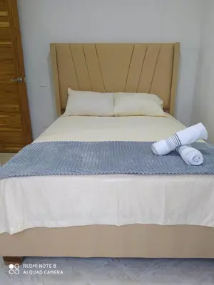 a bed with two towels on top of it at cabañas Brisas y Perla by AMAUNA in Moñitos