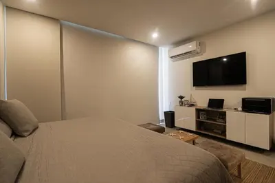 a bedroom with a bed and a flat screen tv at Apartamento en Morros Zoe con acceso directo al mar en Cartagena in Cartagena de Indias
