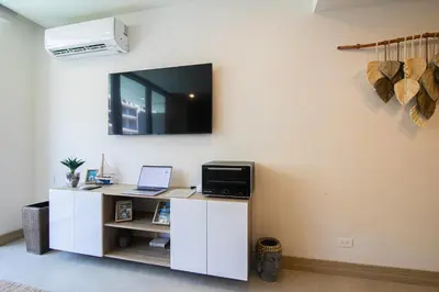 a room with a white desk with a tv on the wall at Apartamento en Morros Zoe con acceso directo al mar en Cartagena in Cartagena de Indias