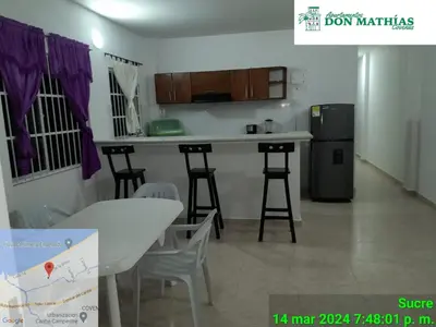 a kitchen with a table and chairs in a room at Don Mathias # 2, Coveñas - Apartamento in Coveñas