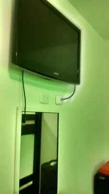 a flat screen tv on a wall above a mirror at Don Mathias # 2, Coveñas - Apartamento in Coveñas
