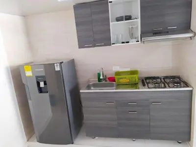 a kitchen with a stainless steel refrigerator and a sink at Apartamento Marbella - En Edificio Frente a la Playa cerca al centro Histórico in Cartagena de Indias