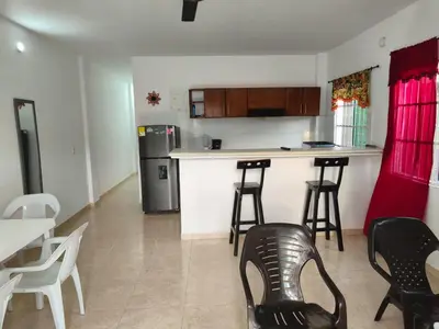a kitchen with a counter and stools in a room at Don Mathias # 1, Coveñas - Apartamento in Coveñas